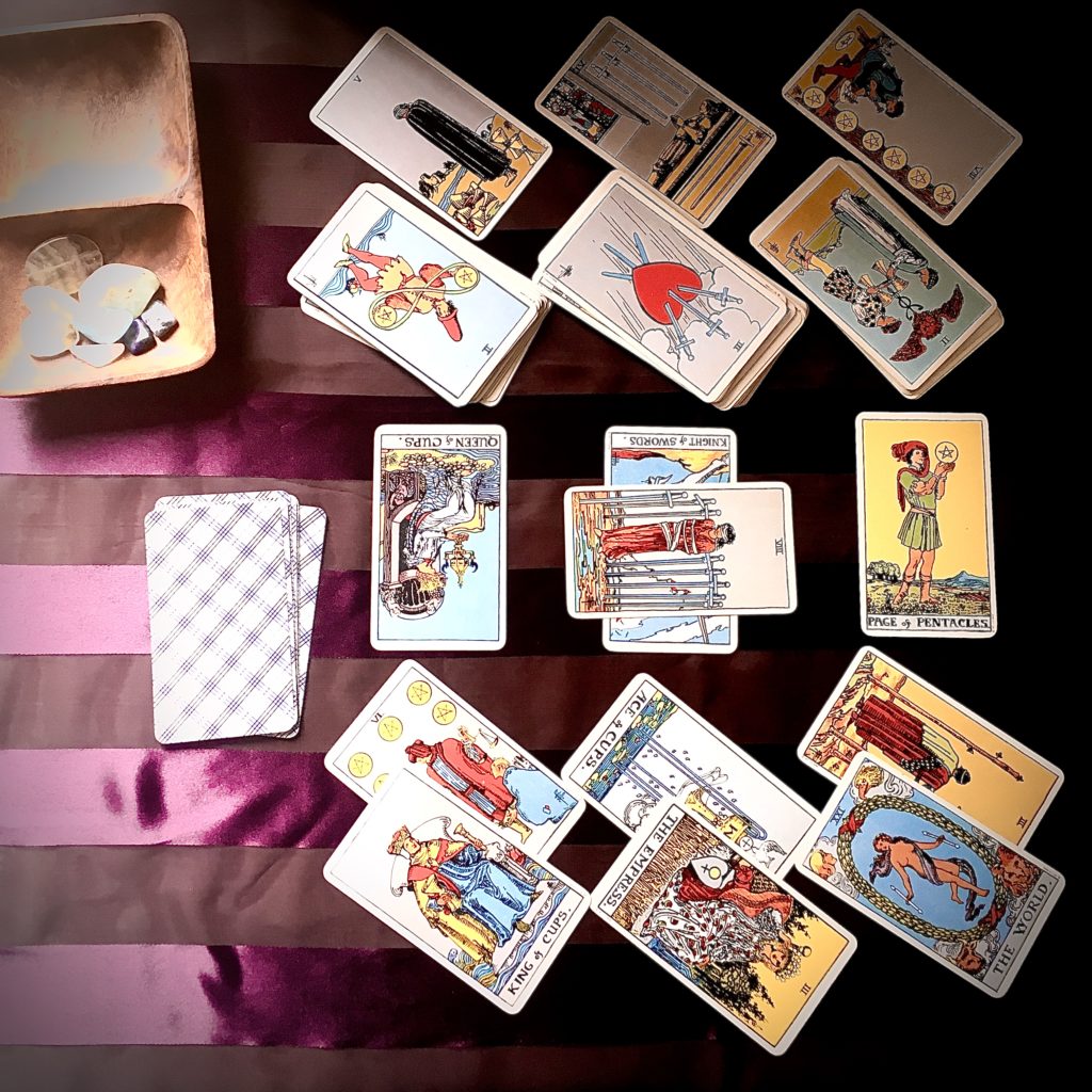 19 tarot cards in a layered non traditional layout