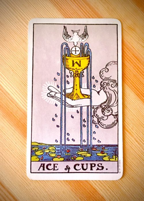Ace of Cups, Rider-Waite-Smith tarot, on wood background